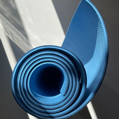 Empty yoga mat in a bright, clean room.